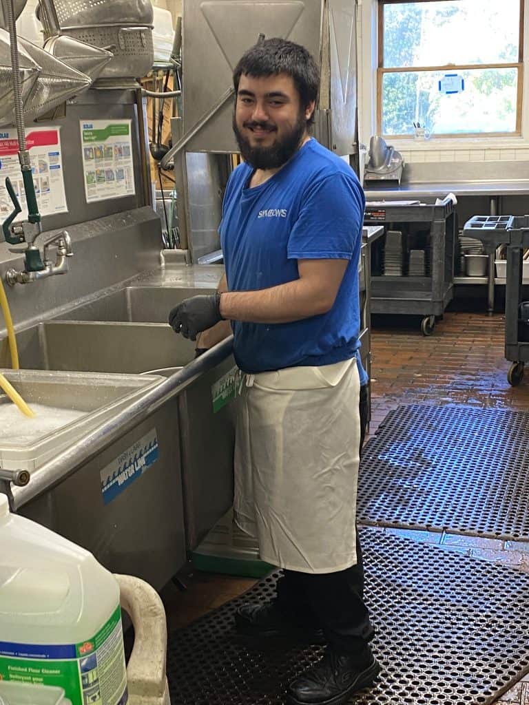 Delicious Greek cuisine at Symeon's Greek Restaurant, friendly staff preparing authentic dishes.