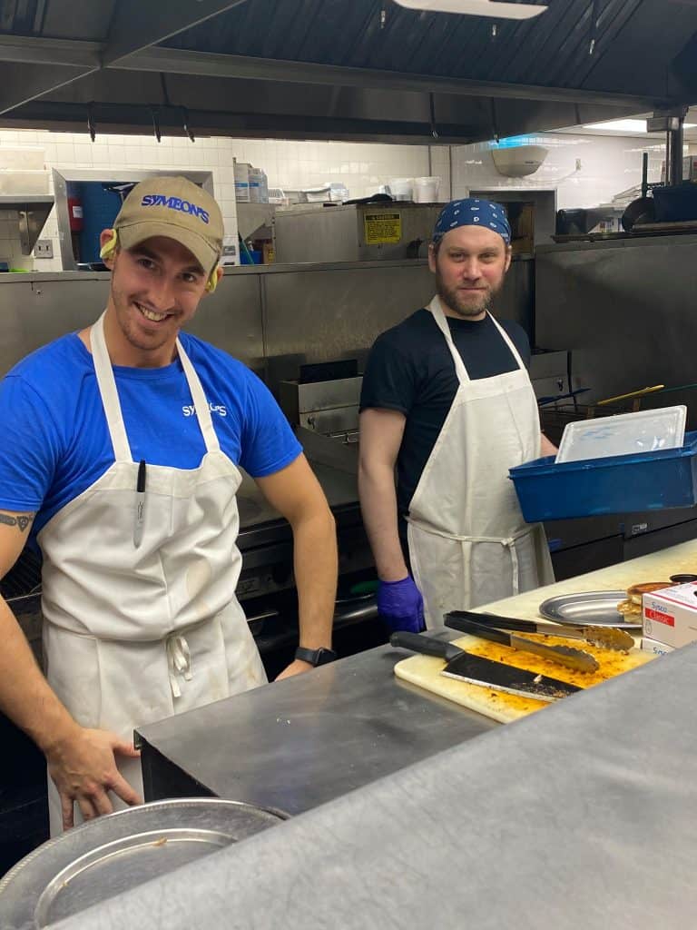 Fresh Greek restaurant chefs preparing traditional dishes at Symeon’s Greek Restaurant.