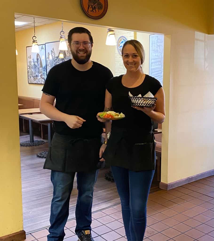 Fresh Greek restaurant staff serving traditional dishes at Symeon’s Greek Restaurant.